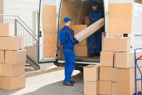 Removal truck and house moving equipment in Chelsea suburb setting
