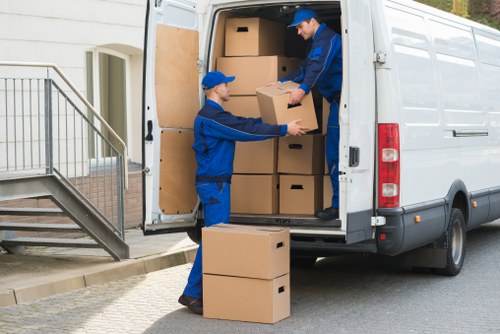 Professional movers loading items near a Chelsea apartment building