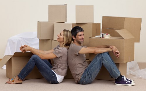 Professional movers handling boxes and furniture carefully