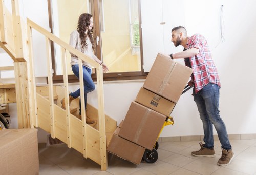 Carrying boxes through a Chelsea residential property